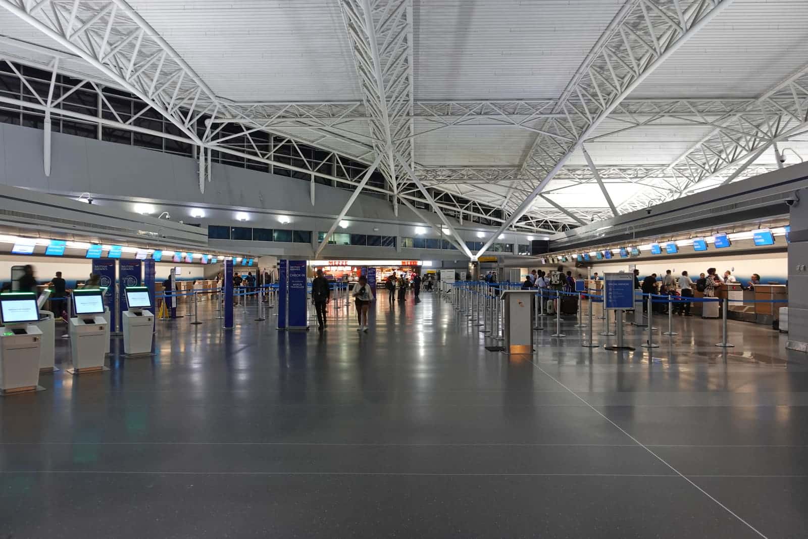 Travelers checking in at the international departure hall of JFK Airport's Terminal 8 in New York