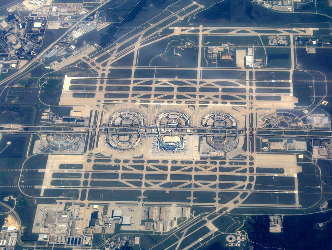 Aerial overview of Dallas-Fort Worth International Airport's terminal complex and runways